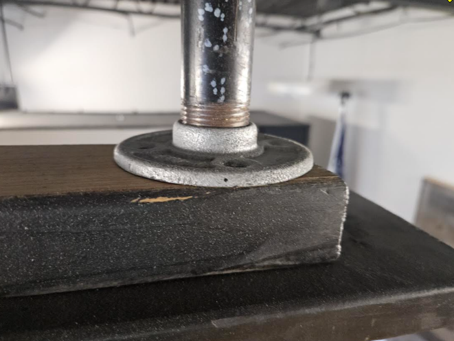A metal pipe on a wood surface

AI-generated content may be incorrect.