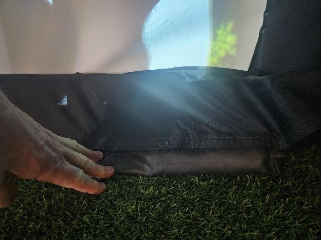 A hand reaching out to a black object on grass

AI-generated content may be incorrect.